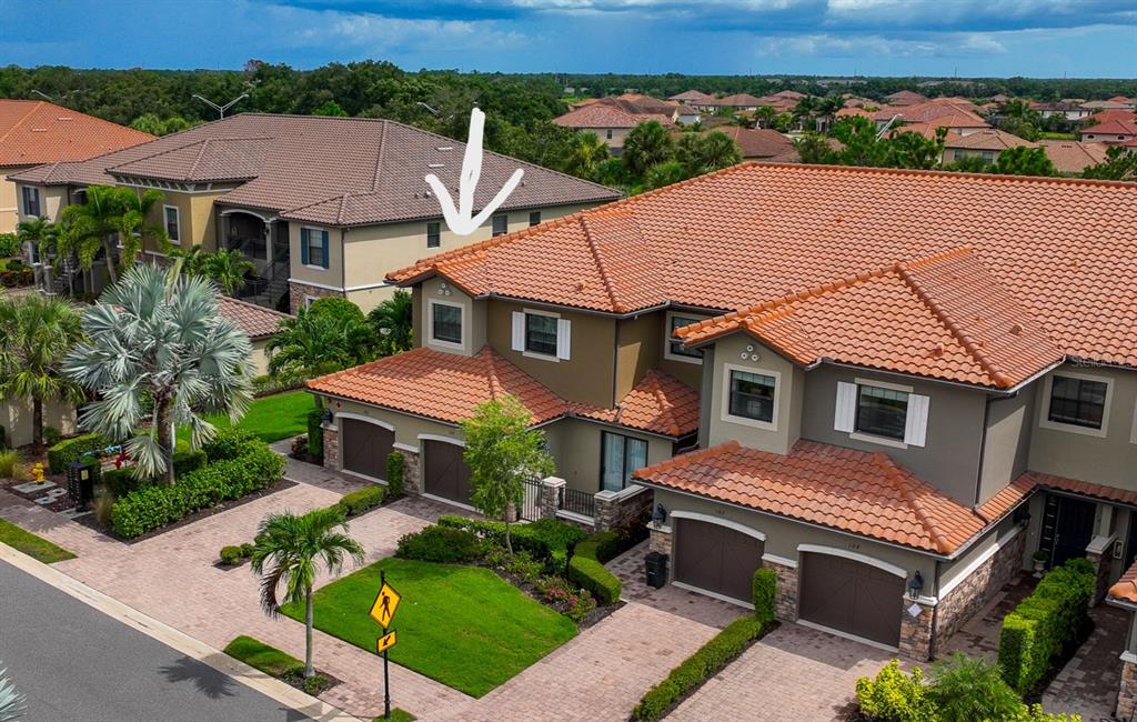 an aerial view of a house with a yard