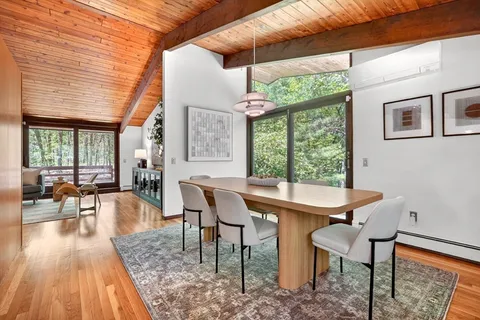 a dining room with furniture and wooden floor