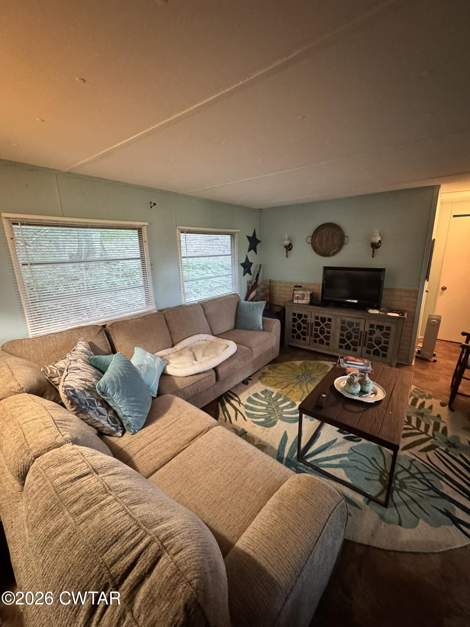 75 Elkins Road Decaturville, TN 38329 - Photo 6 of 8 a living room with furniture and a flat screen tv