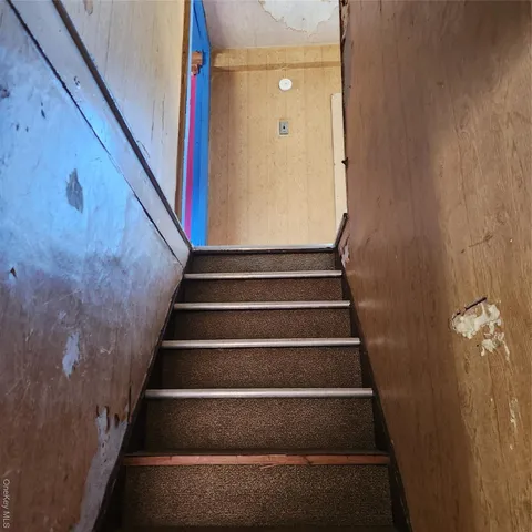 a view of staircase with white walls and a window