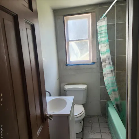 a white toilet sitting next to a small sink