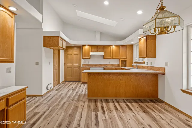 a view of kitchen with cabinets and wooden floor