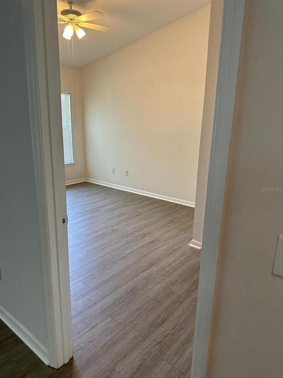 4352 South Kirkman Road, Unit 1204 Orlando, FL 32811 - Photo 11 of 22 a view of a hallway with wooden floor