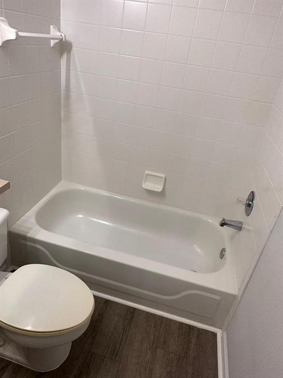 4352 South Kirkman Road, Unit 1204 Orlando, FL 32811 - Photo 17 of 22 a bathroom with a toilet and bathtub