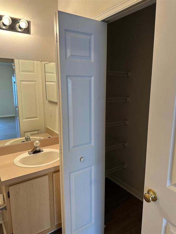 4352 South Kirkman Road, Unit 1204 Orlando, FL 32811 - Photo 20 of 22 a bathroom with a sink and a mirror