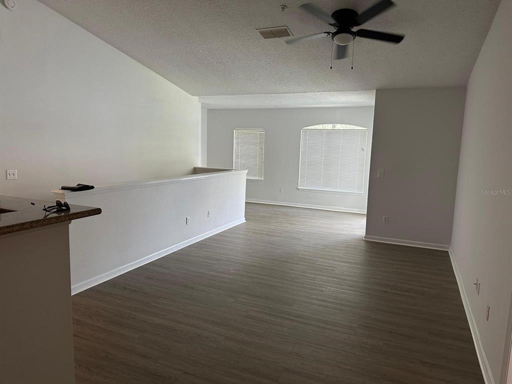 4352 South Kirkman Road, Unit 1204 Orlando, FL 32811 - Photo 6 of 22 wooden floor in an empty room