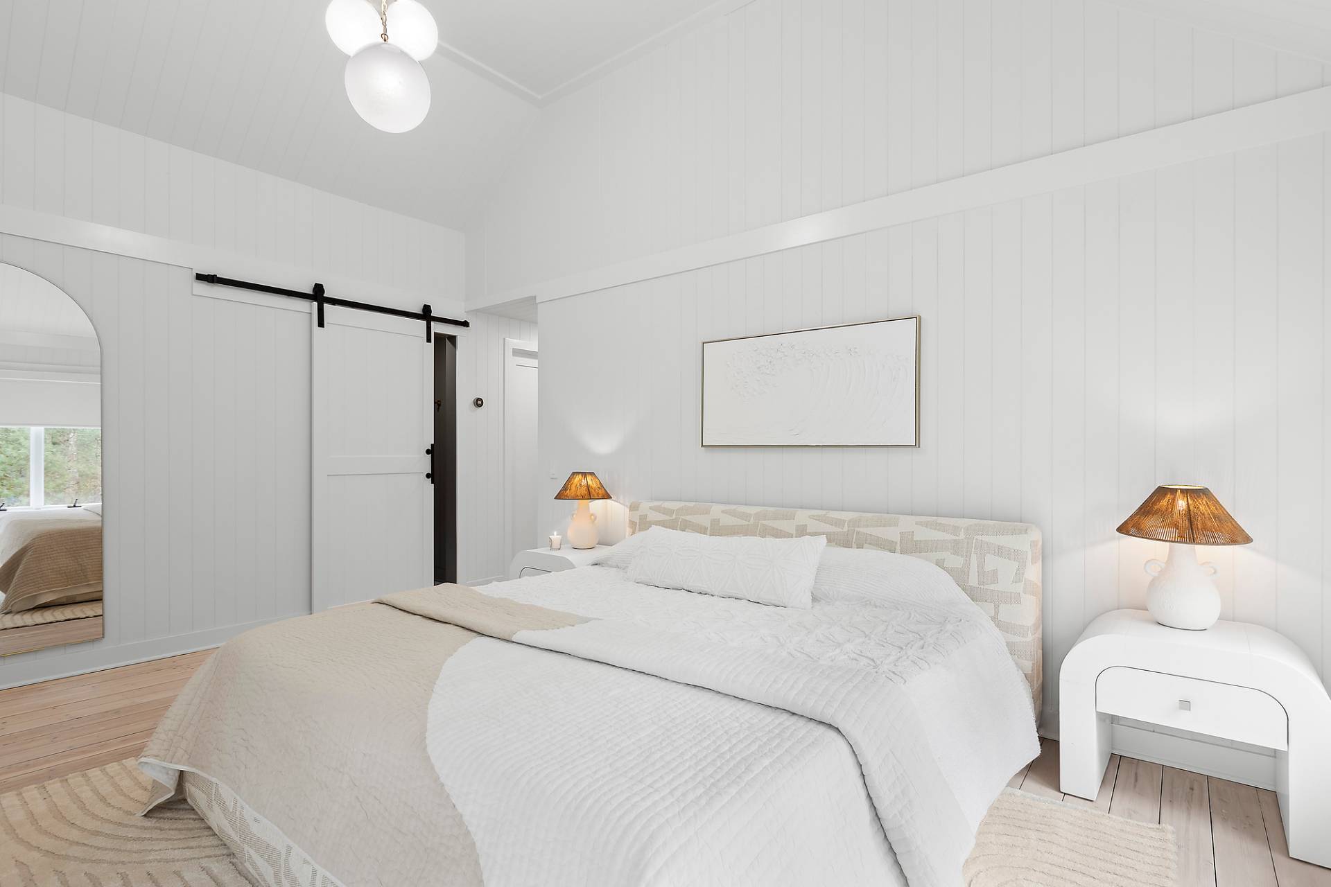 5 Phoebe Scoys Road East Hampton, NY 11937 - Photo 33 of 43 a bedroom with a bed and a chandelier