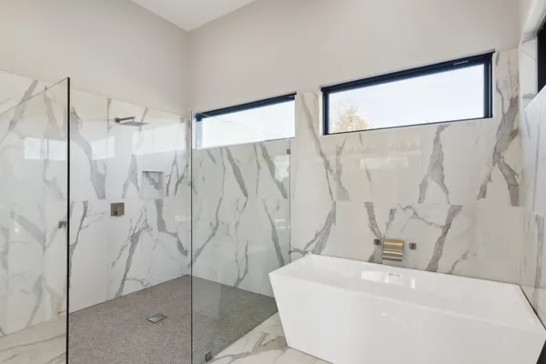a bathroom with a bathtub and shower