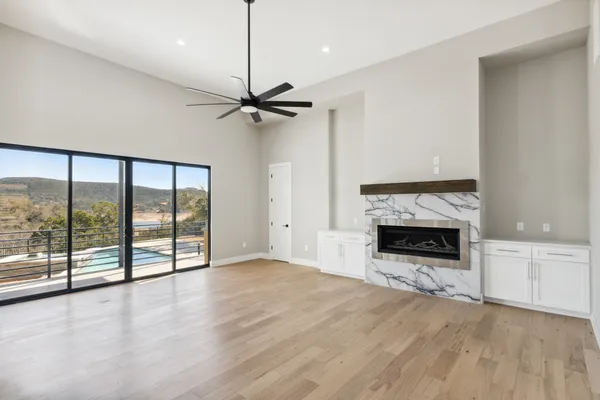 a view of an empty room with a fireplace and a window