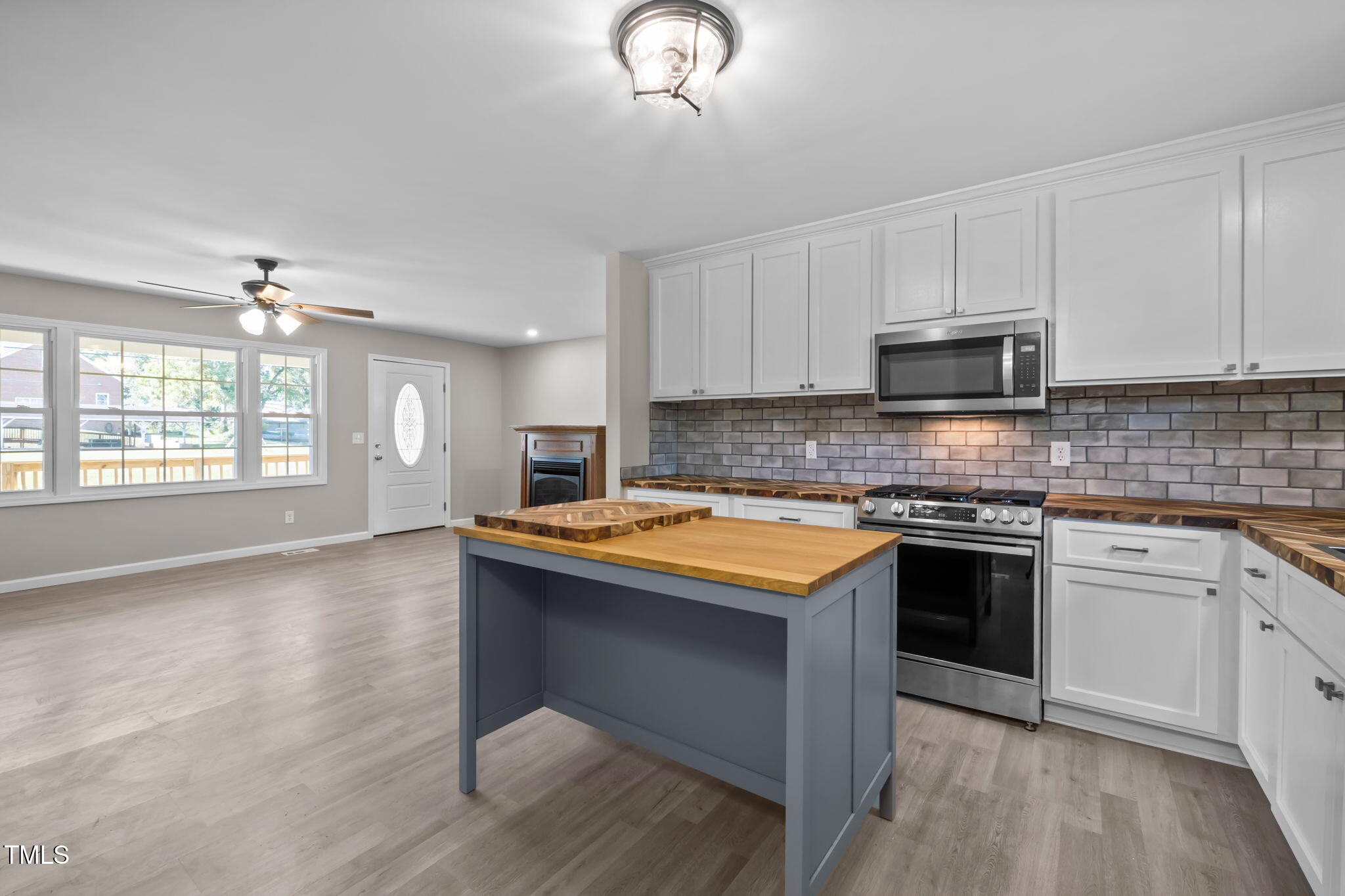 150 Summit Street Roxboro, NC 27573 - Photo 20 of 37 a kitchen with stainless steel appliances granite countertop a stove a sink and a microwave