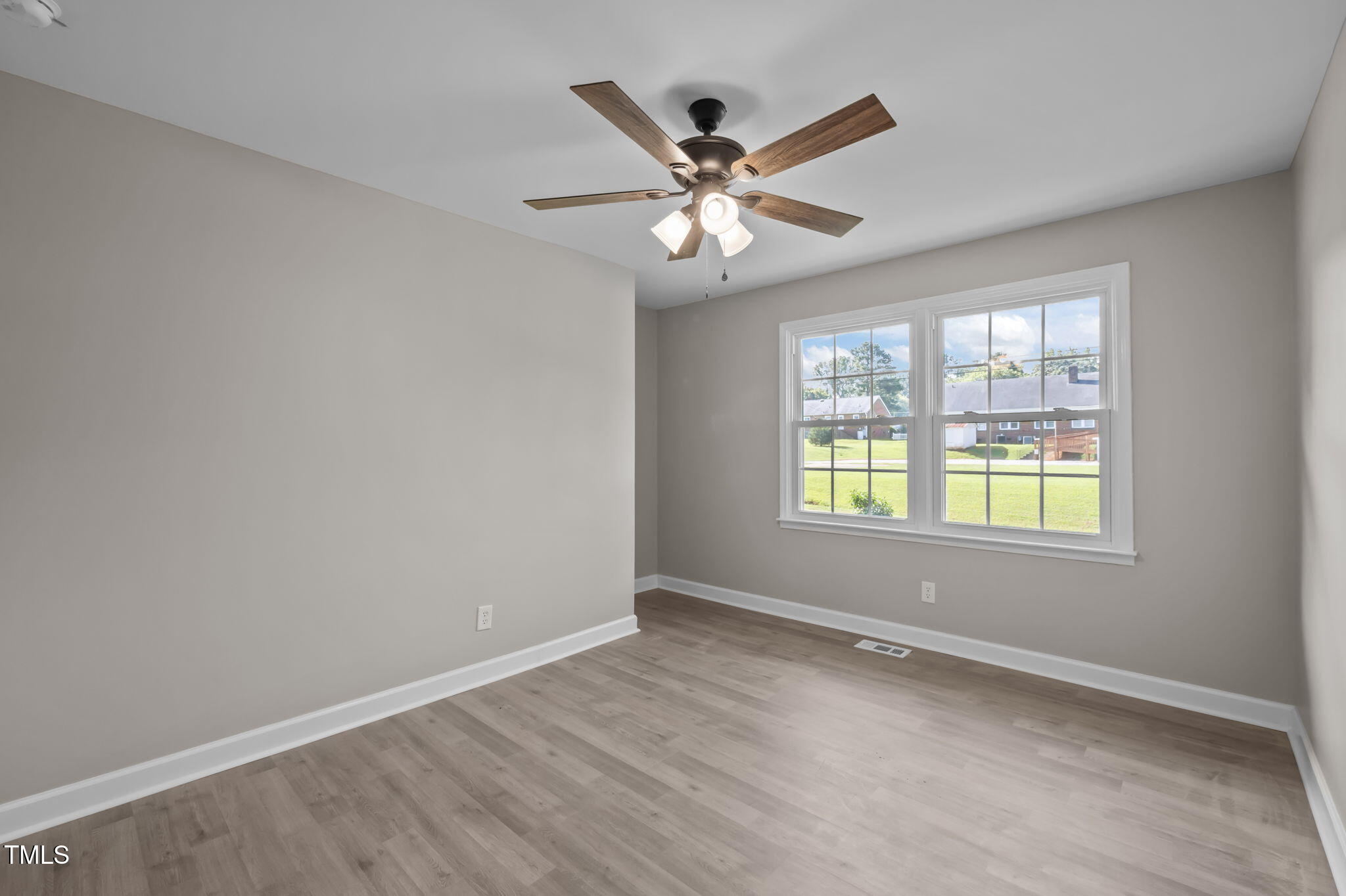 150 Summit Street Roxboro, NC 27573 - Photo 27 of 37 a view of an empty room with chandelier fan and a window