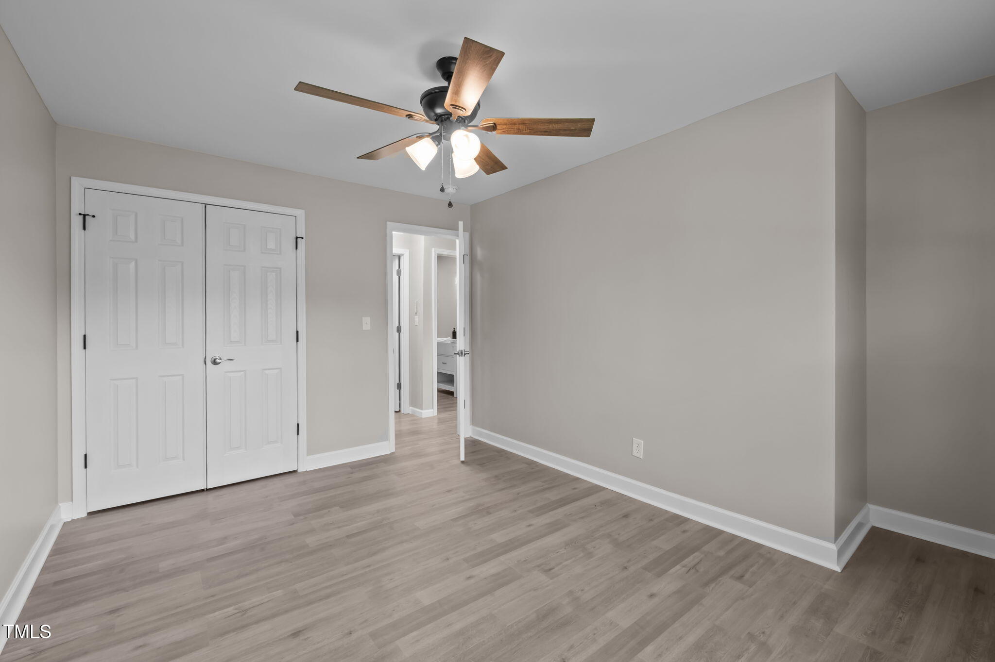 150 Summit Street Roxboro, NC 27573 - Photo 28 of 37 an empty room with wooden floor fan and windows