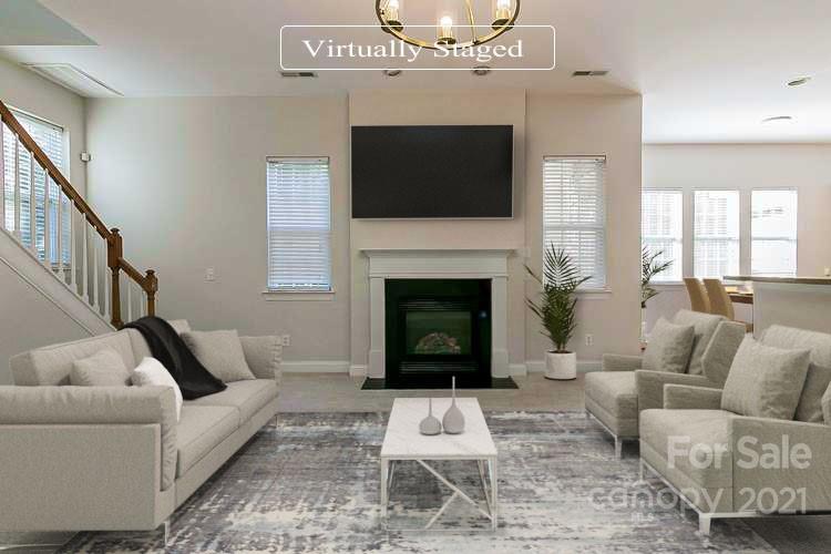 10426 Tom Short Road Charlotte, NC 28277 - Photo 2 of 17 a living room with furniture a flat screen tv and a fireplace
