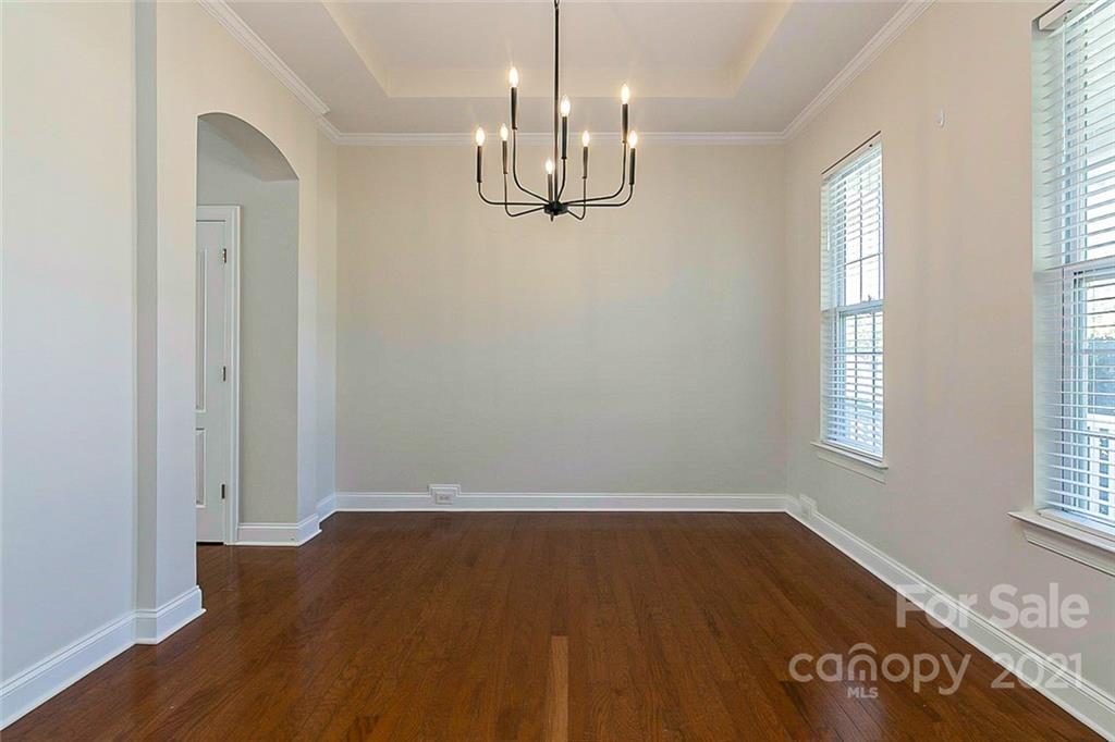 10426 Tom Short Road Charlotte, NC 28277 - Photo 12 of 17 an empty room with wooden floor and windows