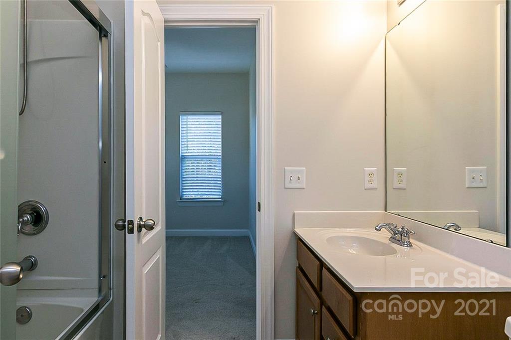 10426 Tom Short Road Charlotte, NC 28277 - Photo 15 of 17 a bathroom with a sink and mirror with tub