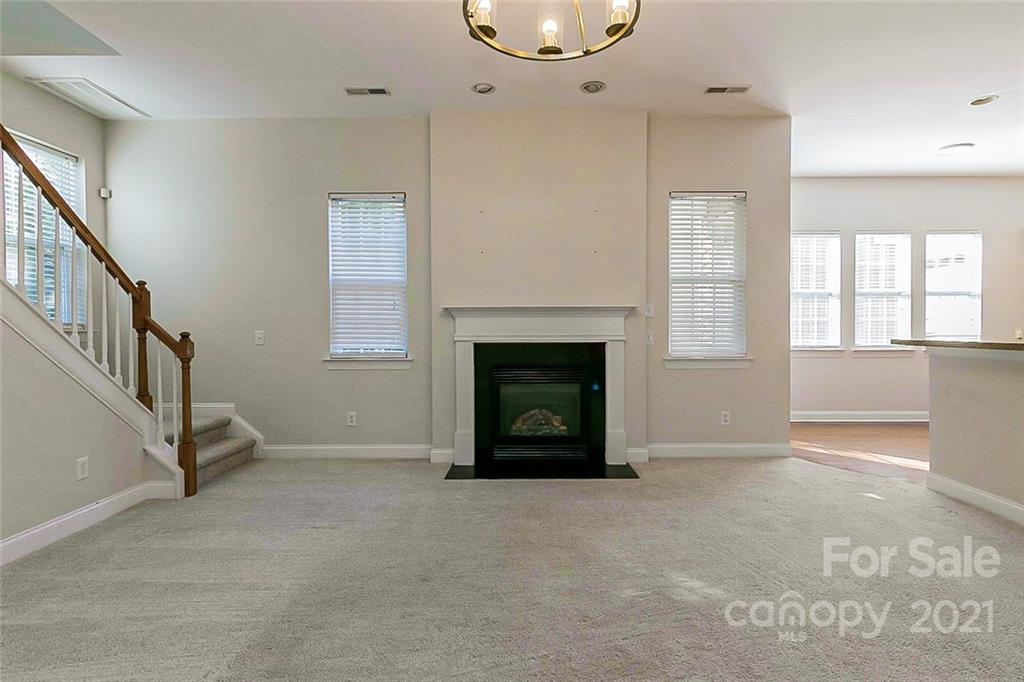 10426 Tom Short Road Charlotte, NC 28277 - Photo 3 of 17 a view of an empty room with a fireplace and a window