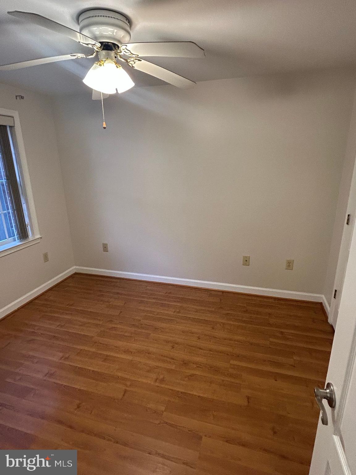 6924 Fairfax Drive, Unit 140 Arlington, VA 22213 - Photo 11 of 19 a view of a room with wooden floor and chandelier