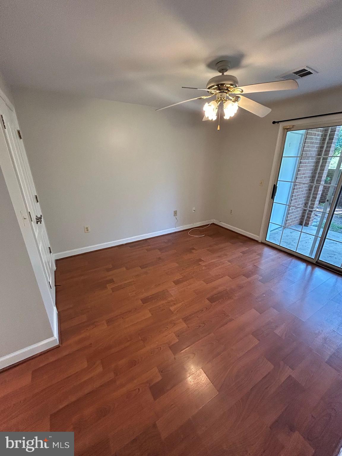 6924 Fairfax Drive, Unit 140 Arlington, VA 22213 - Photo 14 of 19 a view of an empty room with a window and wooden floor