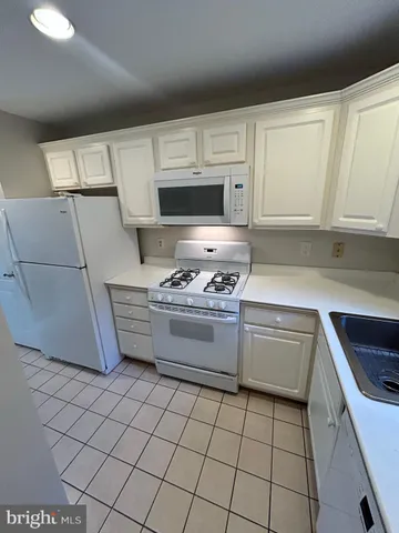 a kitchen with cabinets and appliances