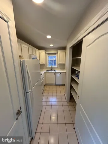 a kitchen with refrigerator and window