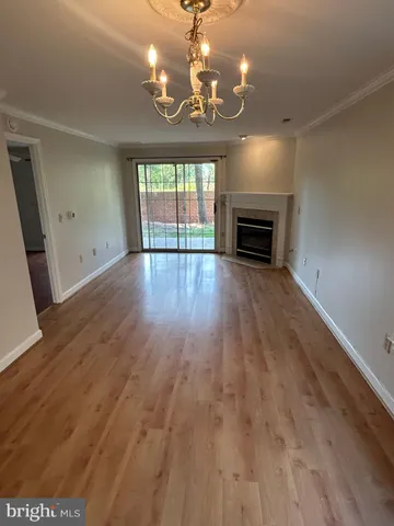 wooden floor in an empty room with a fireplace