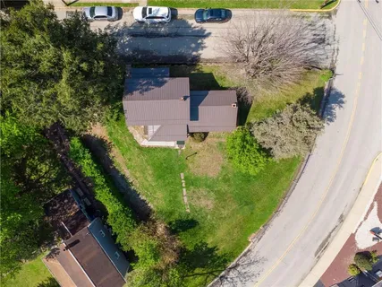 an aerial view of a house with a garden