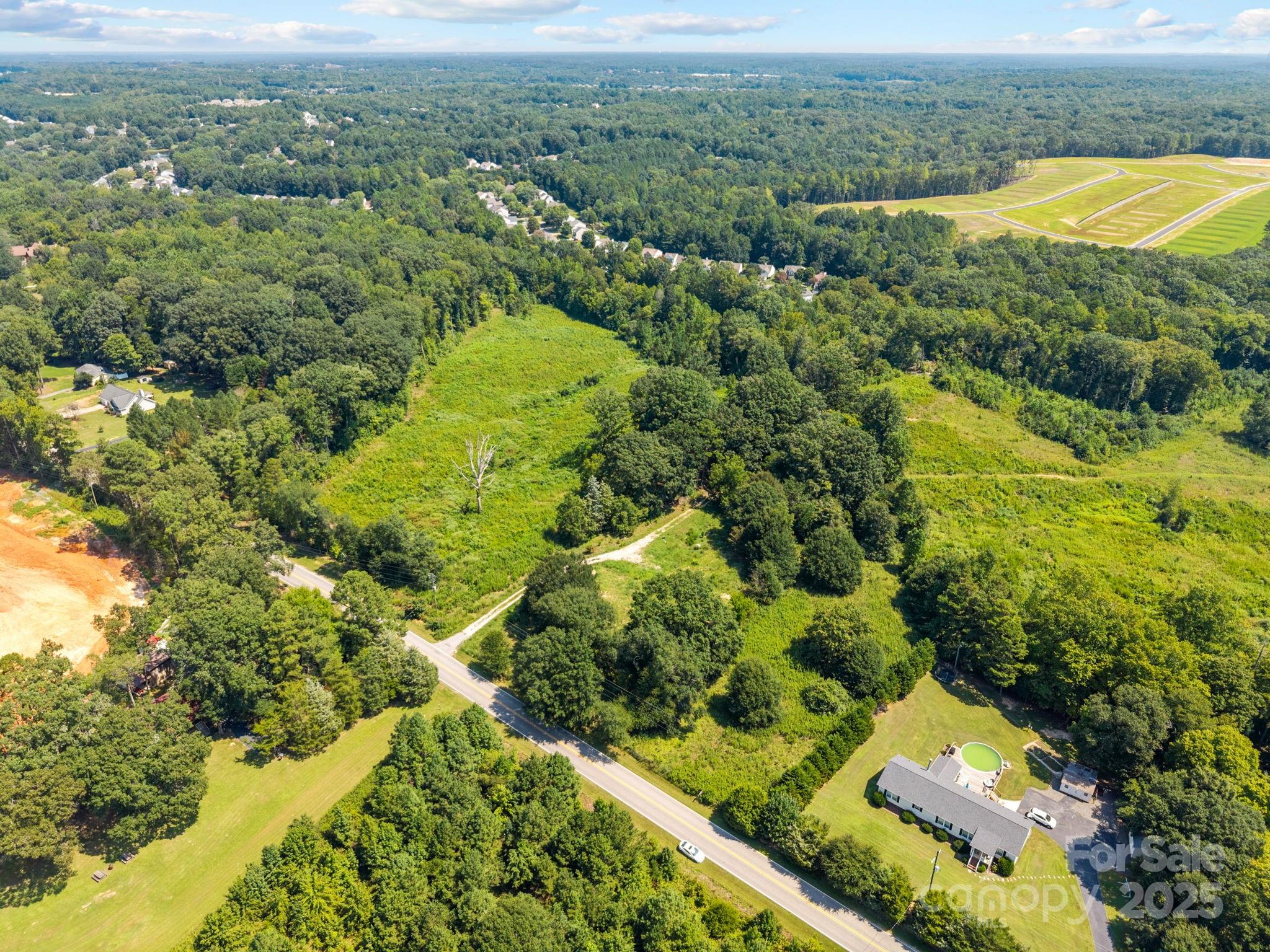0 Henry Harris Road, Unit 6 Fort Mill, SC 29707 - Photo 2 of 25 an aerial view of residential houses with outdoor space and swimming pool