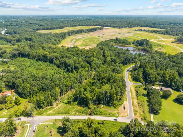 a view of a swimming pool with an outdoor seating and a yard