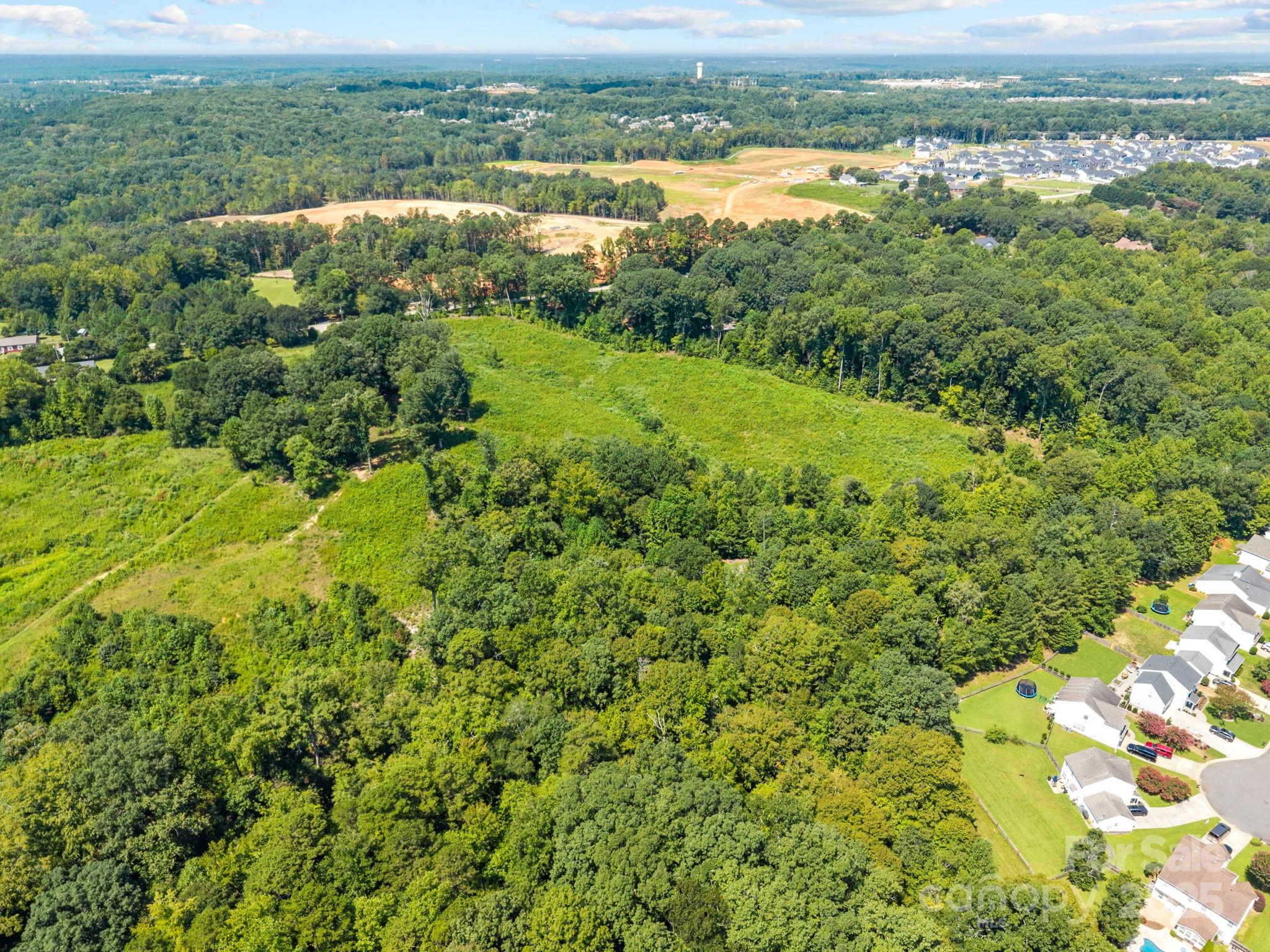 0 Henry Harris Road, Unit 6 Fort Mill, SC 29707 - Photo 7 of 25 a view of a city with lush green forest