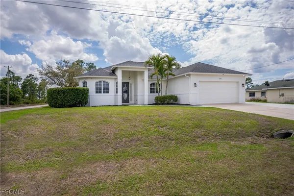 a front view of a house with a yard and garage