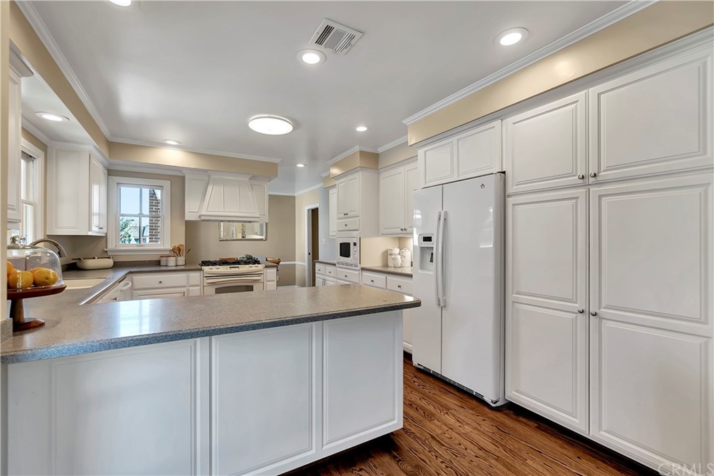 111 West Lemon Avenue Arcadia, CA 91007 - Photo 16 of 46 a kitchen with stainless steel appliances granite countertop a refrigerator a sink dishwasher a stove and white cabinets with wooden floor