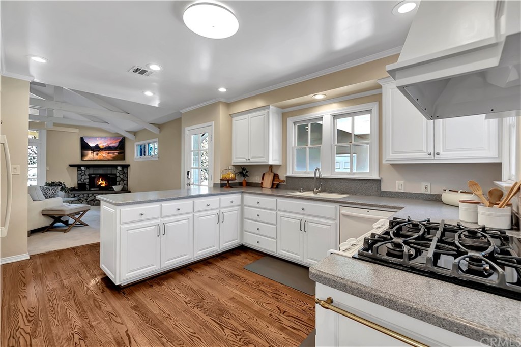 111 West Lemon Avenue Arcadia, CA 91007 - Photo 18 of 46 a kitchen with stainless steel appliances a stove a sink a refrigerator and white cabinets