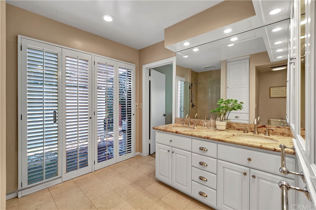 111 West Lemon Avenue Arcadia, CA 91007 - Photo 31 of 46 a bathroom with a granite countertop sink mirror and a shower