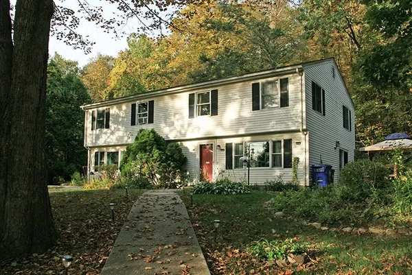 a front view of house with yard and green space