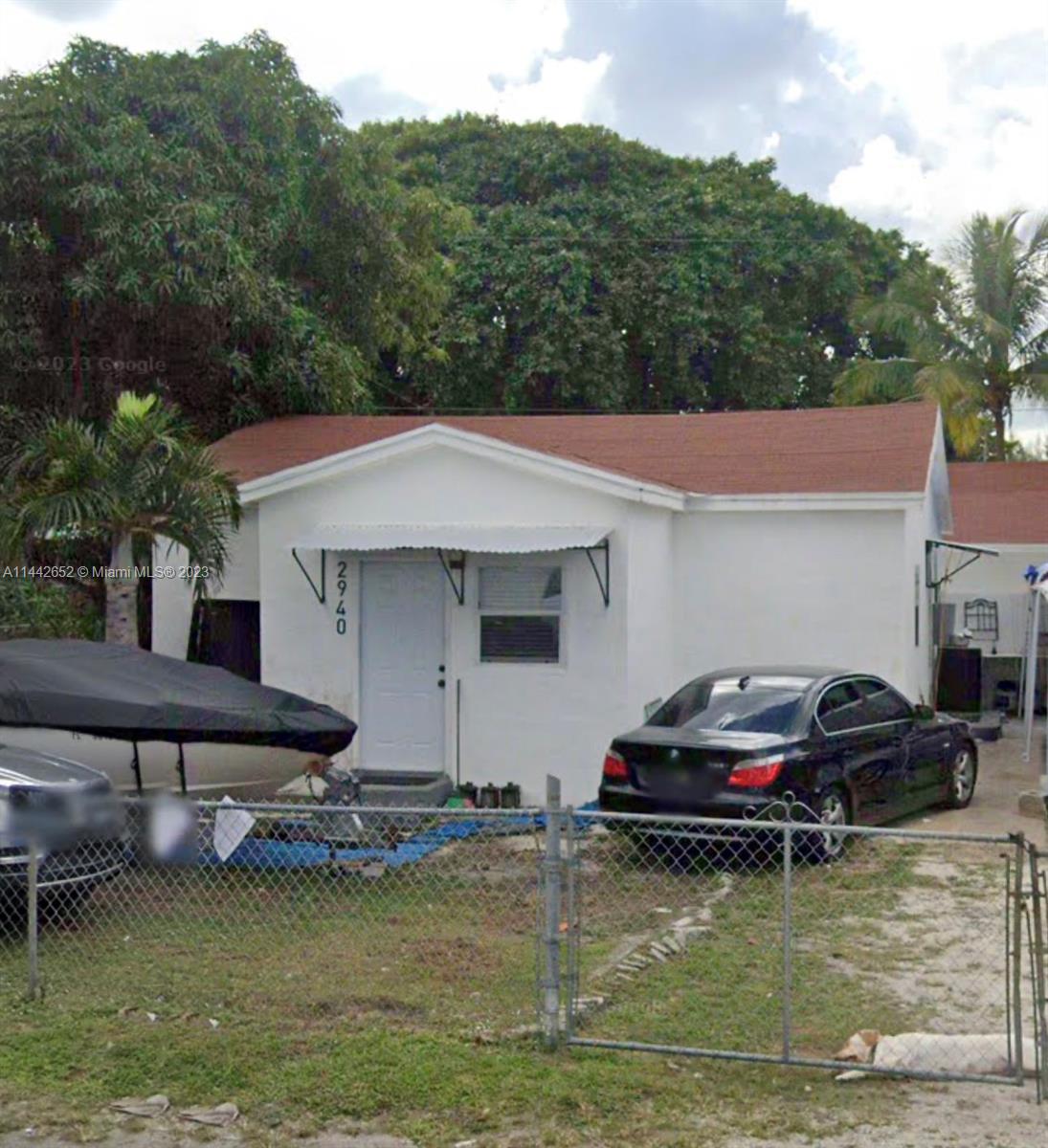 2940 Northwest 88th Street, Unit A Miami, FL 33147 - Photo 1 of 5 a small swimming pool is sitting in the middle of a lake