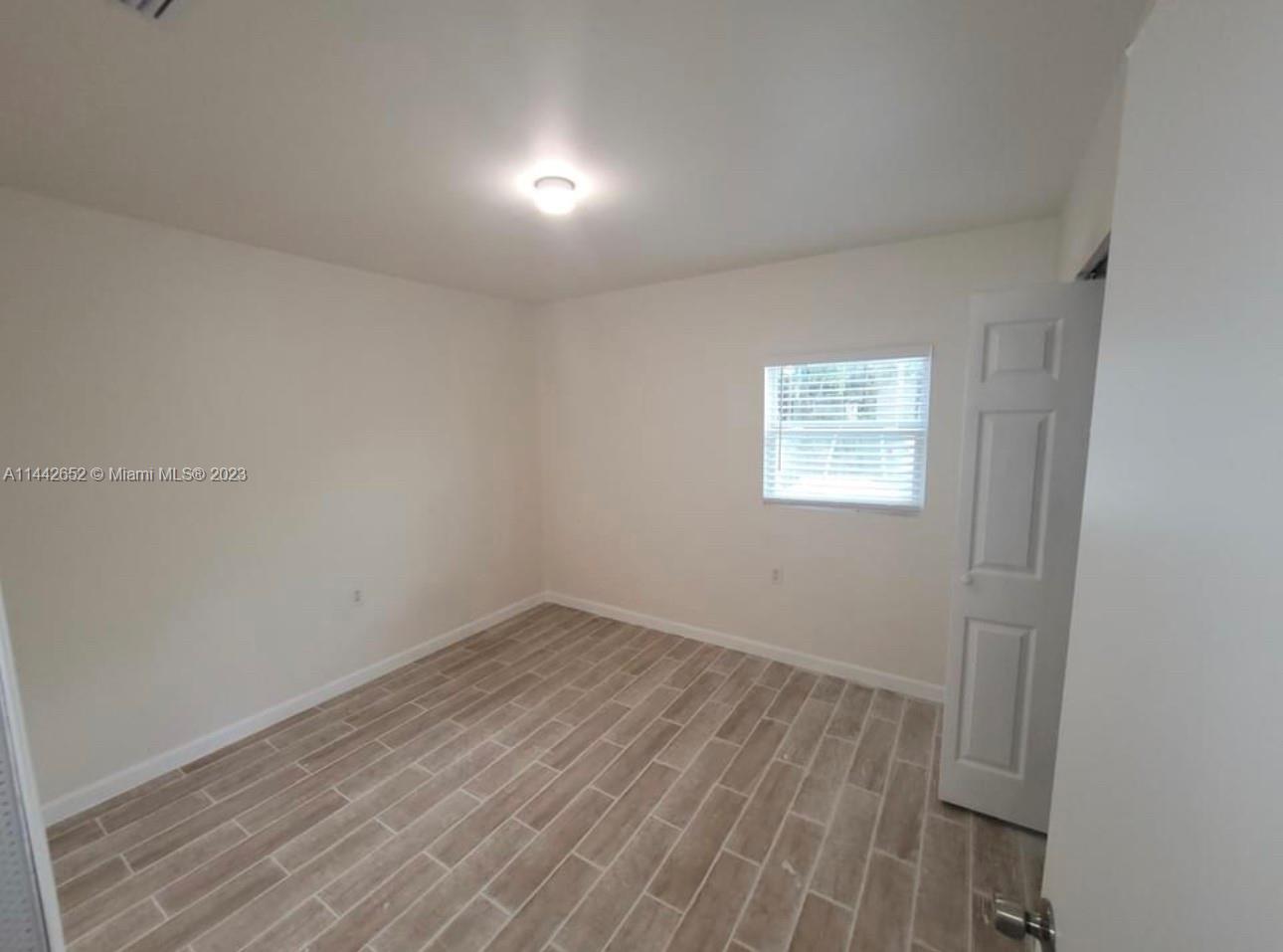 2940 Northwest 88th Street, Unit A Miami, FL 33147 - Photo 4 of 5 wooden floor in a empty room