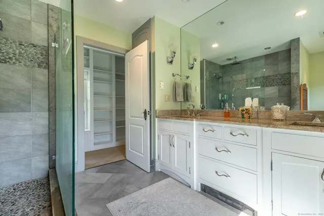 a bathroom with a shower sink and mirror