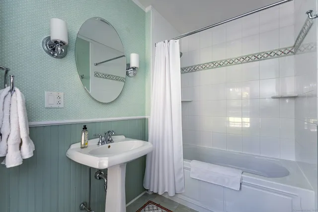 a bathroom with a sink a mirror and a shower