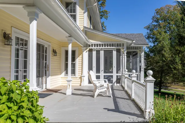a view of a patio with table and chairs and potted plants