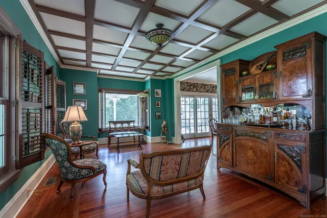 a living room with furniture or chandelier and a wooden floor