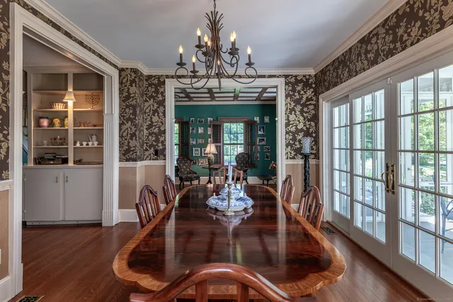 a view of a dining room with furniture wooden floor and chandelier