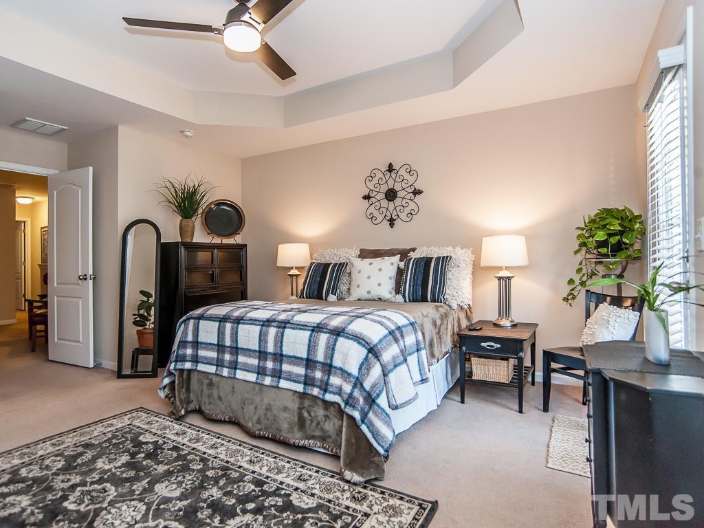 1311 Still Monument Way Raleigh, NC 27603 - Photo 16 of 33 a bedroom with a bed and a chandelier