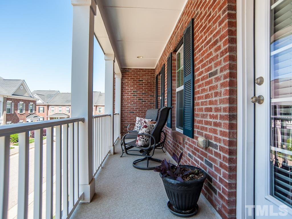 1311 Still Monument Way Raleigh, NC 27603 - Photo 18 of 33 a view of a balcony with chair and potted plants