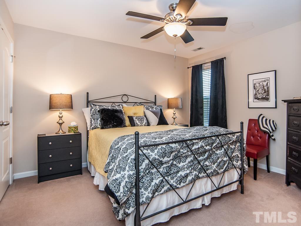 1311 Still Monument Way Raleigh, NC 27603 - Photo 21 of 33 a bedroom with a bed and a chandelier