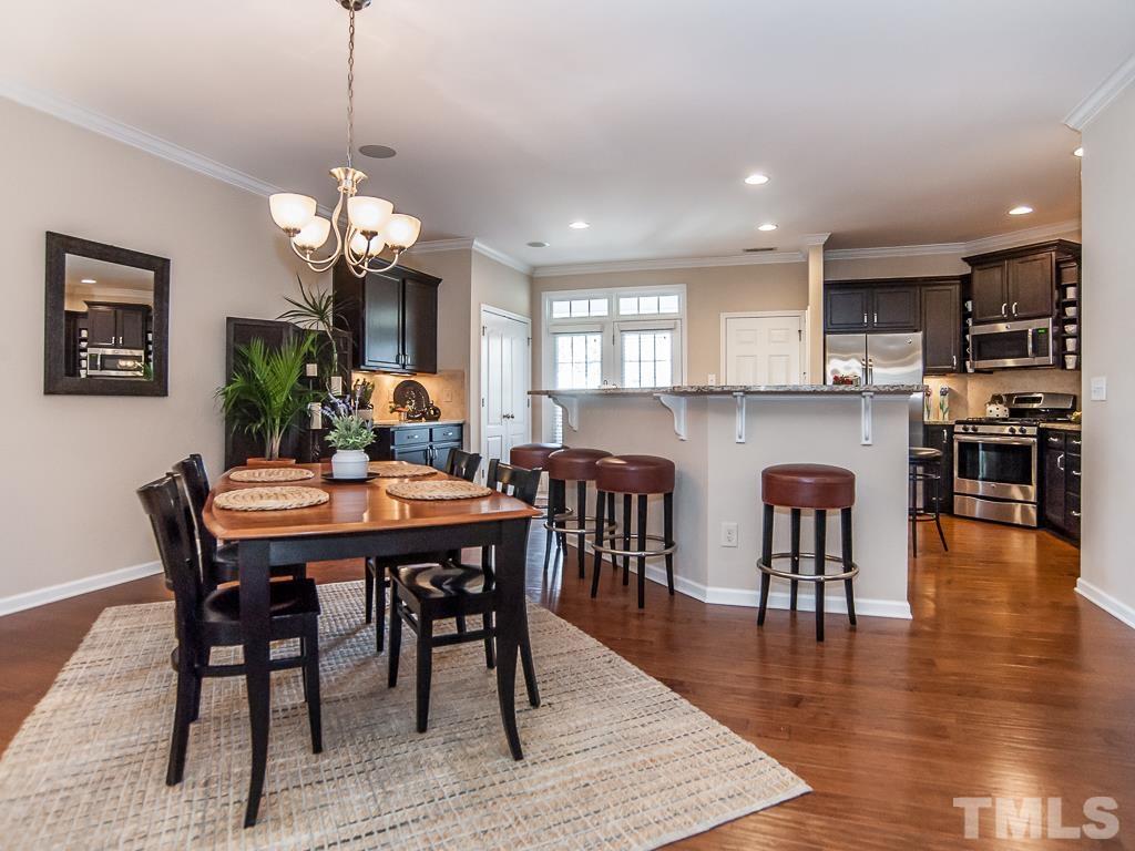1311 Still Monument Way Raleigh, NC 27603 - Photo 7 of 33 a view of a dining room and livingroom with furniture wooden floor a chandelier
