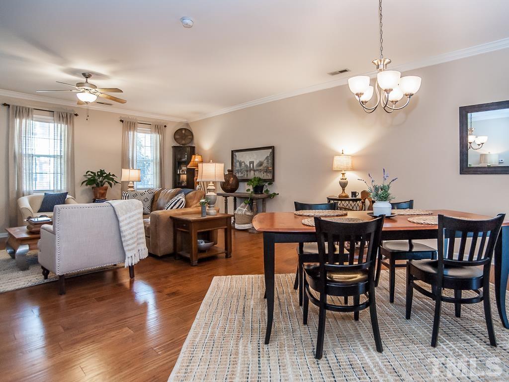 1311 Still Monument Way Raleigh, NC 27603 - Photo 8 of 33 a view of a dining room with furniture and wooden floor