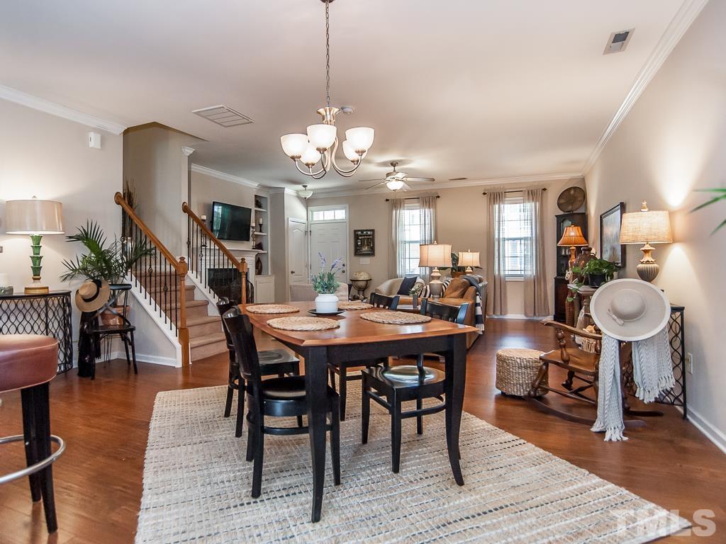 1311 Still Monument Way Raleigh, NC 27603 - Photo 9 of 33 a view of a dining room with furniture and wooden floor