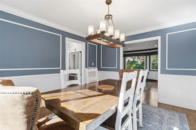 a view of a dining room with furniture wooden floor and chandelier