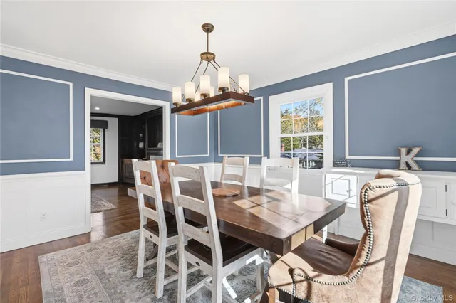 a view of a dining room with furniture and window