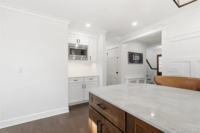 a kitchen with a sink cabinets and wooden floor